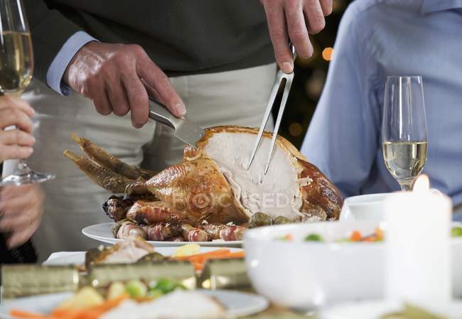 Closeup view of person carving the Christmas turkey — Stock Photo