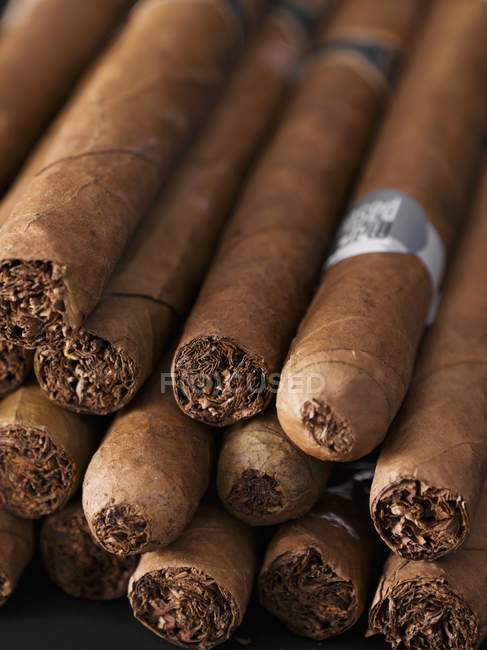 Closeup view of brown cigars in a heap — Stock Photo