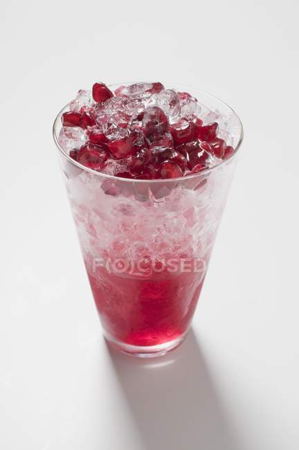 Ice and pomegranate seeds — Stock Photo