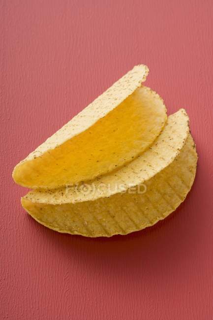 Closeup view of two Taco shells on red background — Stock Photo