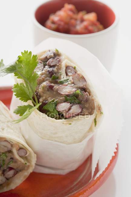 Burritos de haricots, salsa dans un petit bol sur une surface blanche — Photo de stock