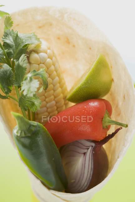 Ingredients for wraps over green surface — Stock Photo
