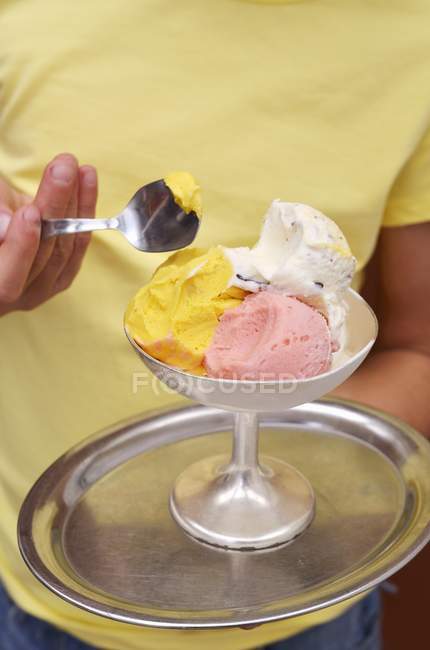 Girl holding a mixed ice cream sundae — Stock Photo