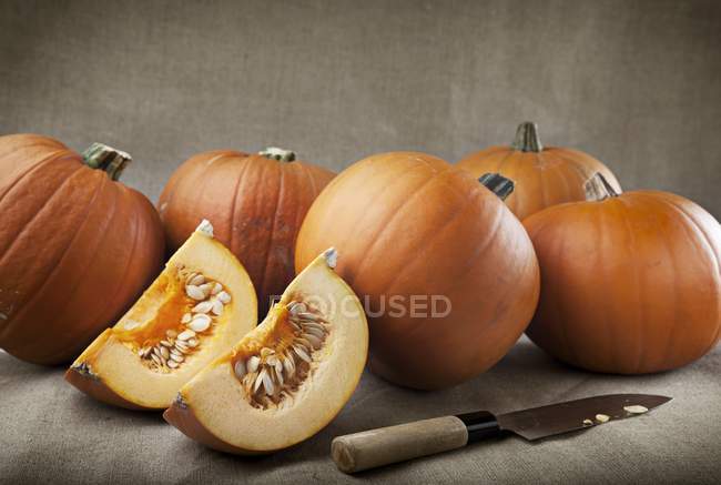 Fresh pumpkins and wedges — Stock Photo