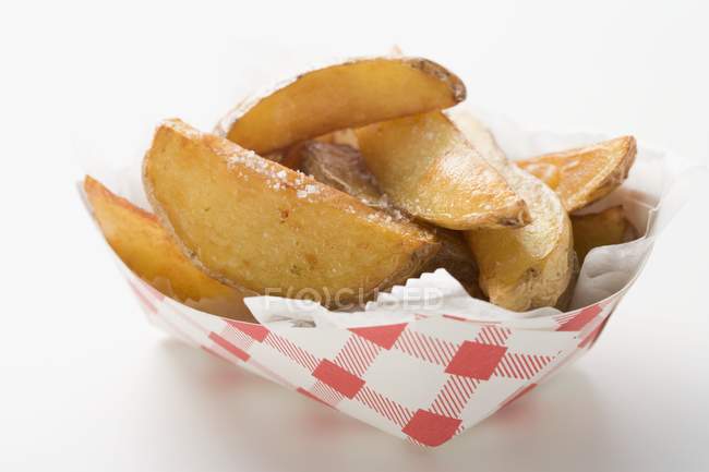Potato wedges in cardboard container — Stock Photo