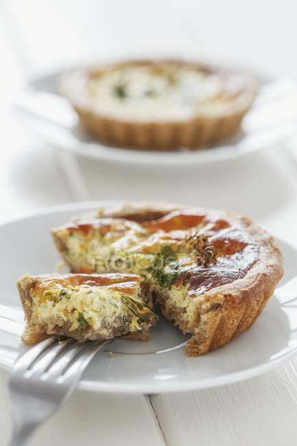 Closeup view of a cut Quiche with herbs — Stock Photo