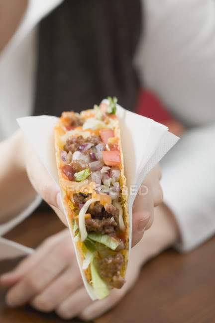 Woman holding taco — Stock Photo