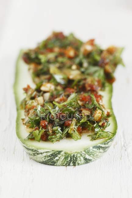Courgette marinated in chermoula on wooden surface — Stock Photo