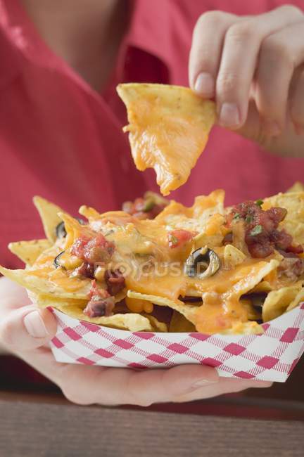 Woman holding nachos — Stock Photo