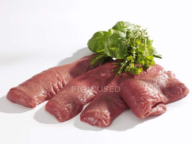 Fresh pieces of lamb with herbs — Stock Photo
