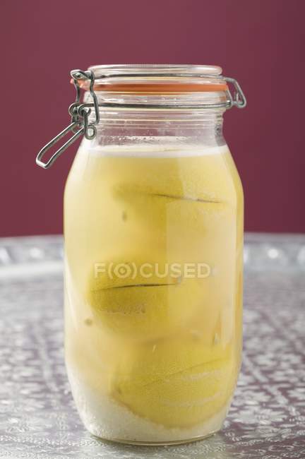 Closeup view of pickled lemons in glass jar — Stock Photo
