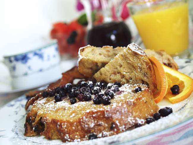 Closeup view of French toasts with blueberries and powdered sugar — Stock Photo