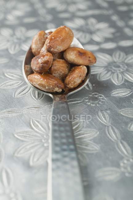 Roasted almonds on spoon — Stock Photo