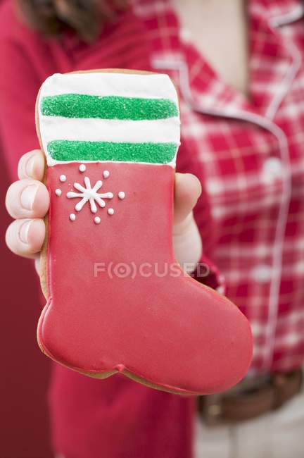 Hand holding gingerbread boot — Stock Photo