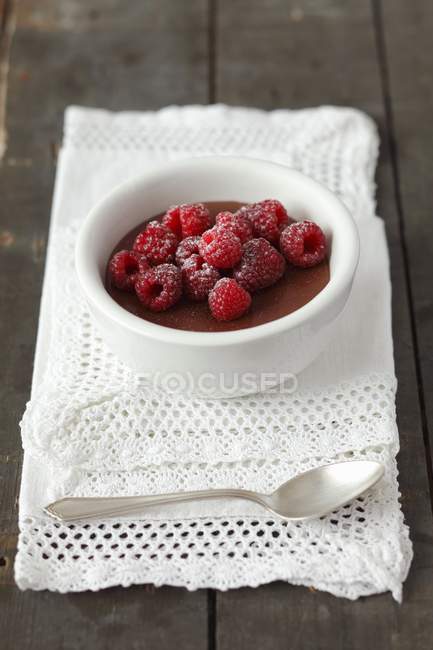 Chocolate pudding topped with raspberries — Stock Photo