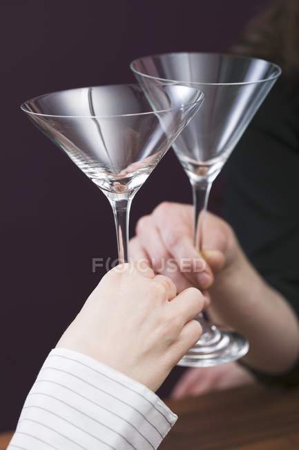 Hands clinking glasses — Stock Photo