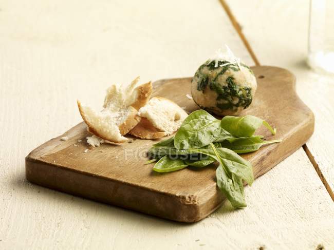 Spinach dumplings with ingredients on wooden desk — Stock Photo