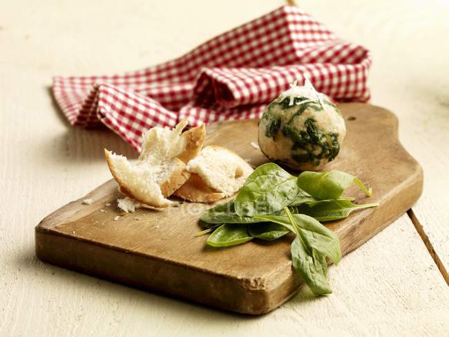 Spinach dumplings with ingredients on wooden desk over table — Stock Photo