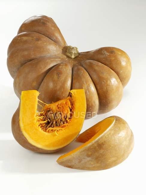 Fresh pumpkin with slices — Stock Photo