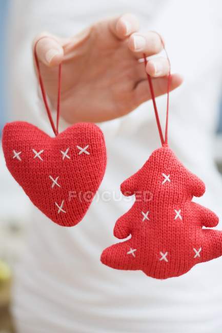 Female Hand holdingChristmas tree ornaments — Stock Photo