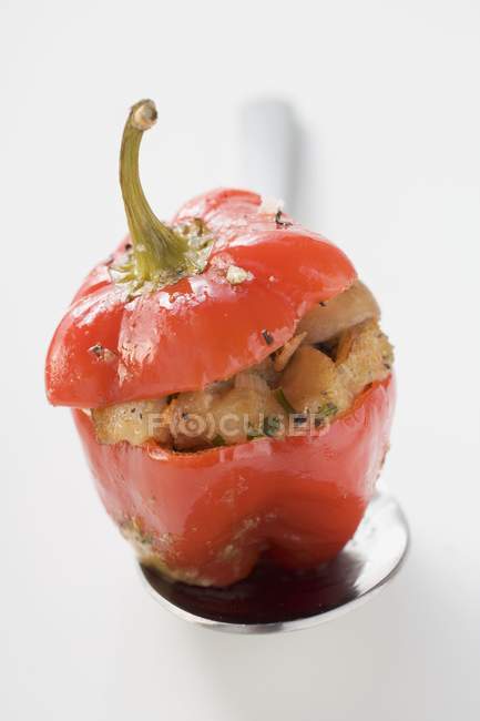 Pepper with bread and mushroom stuffing on spoon  on white background — Stock Photo