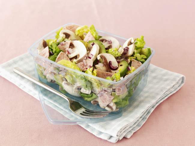 Mushrooms salad with avocado and sausage in a lunchbox over towel — Stock Photo