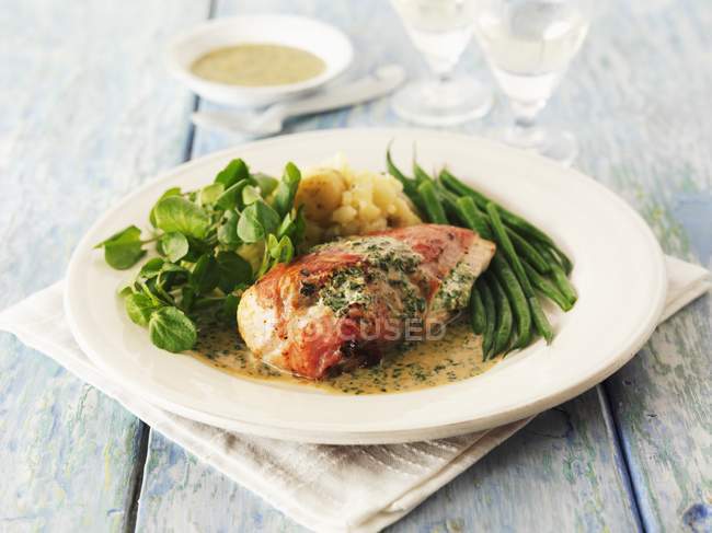 Stuffed chicken breast with herb sauce — Stock Photo
