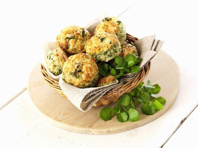 Closeup view of scones with watercress in a bread basket — Stock Photo