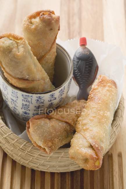 Closeup elevated view of crispy spring rolls with soy sauce — Stock Photo