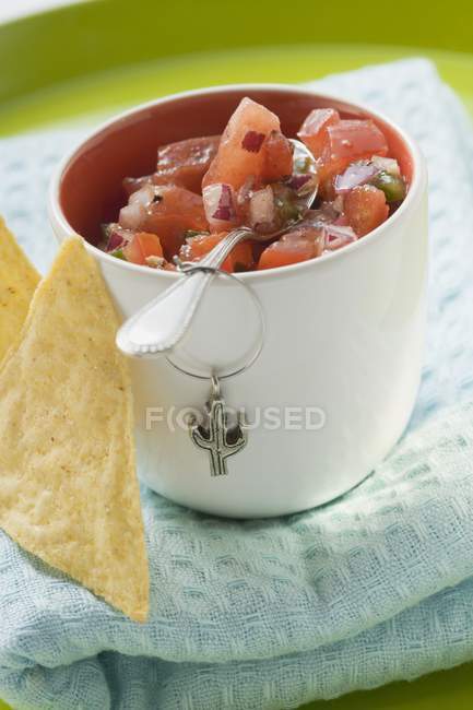 Tomato salsa in pot with spoon — Stock Photo