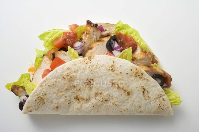 Closeup top view of one chicken Taco on white surface — Stock Photo