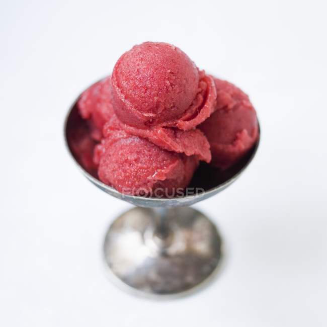 Raspberry ice cream in a sundae dish — Stock Photo