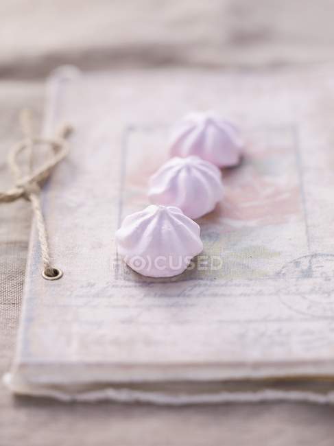 Meringues on a vintage book — Stock Photo