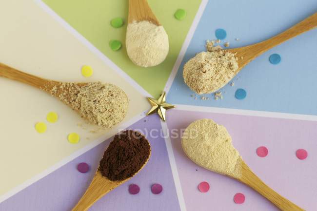 Closeup top view of gluten-free ingredients including grape seed powder, baobab powder, lucuma powder, tigernut powder and brown millet flour — Stock Photo