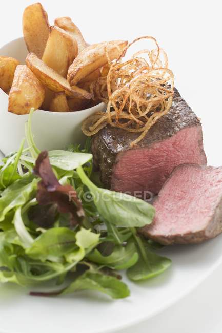 Beef fillet with deep-fried onions — Stock Photo