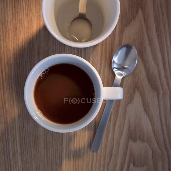 Cup of coffee with spoon — Stock Photo