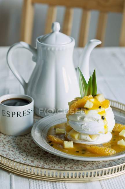 Closeup view of Pavlova with exotic fruits and coffee — Stock Photo