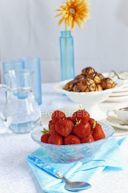 Fresh strawberries in glass bowl — Stock Photo