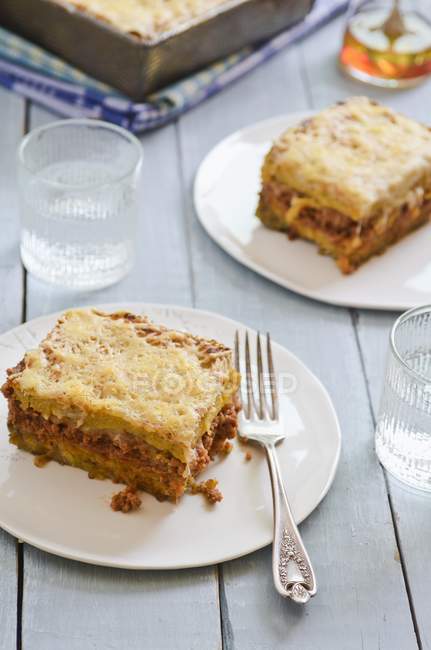 Lasagne with mince on white plates — Stock Photo