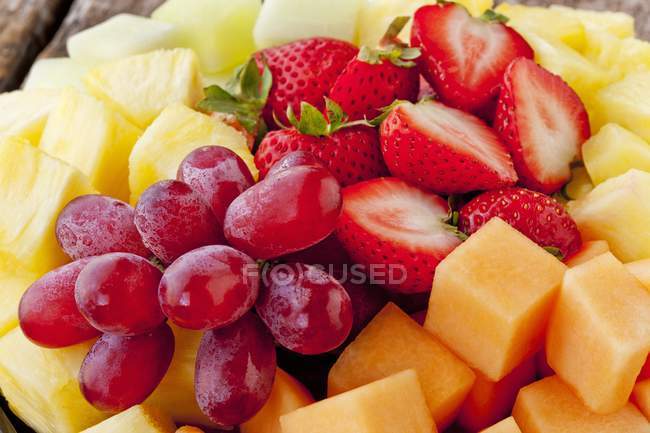 Fresh fruits and berries in heap — Stock Photo