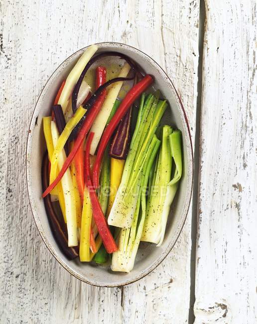 Assorted Vegetable Sticks in an Oval Dish over wooden surface — Stock Photo