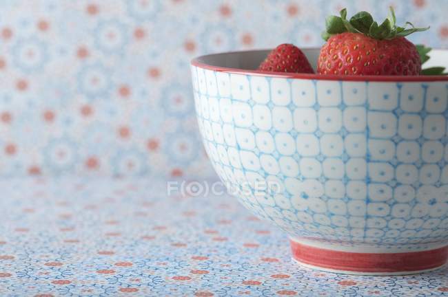 Strawberries in colorful patterned bowl — Stock Photo