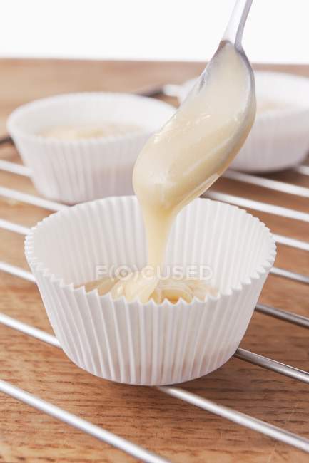 Muffin mixture being put into paper cases — Stock Photo
