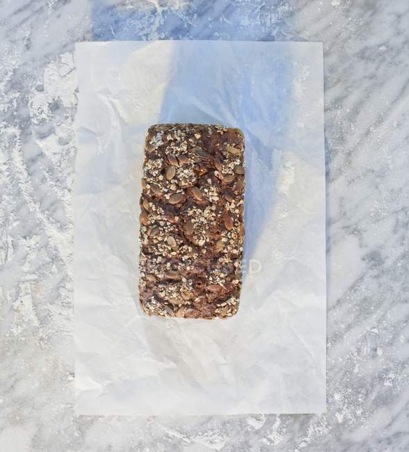 Loaf topped with oats and sunflower seeds — Stock Photo