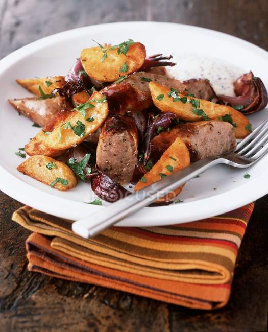 Fried sausage with wedges — Stock Photo