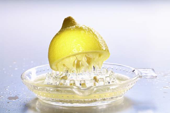 Half of resh lemon on squeezer — Stock Photo