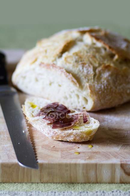 Loaf of bread and ham — Stock Photo