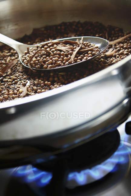Closeup view of dry roasting spices in a pan — Stock Photo