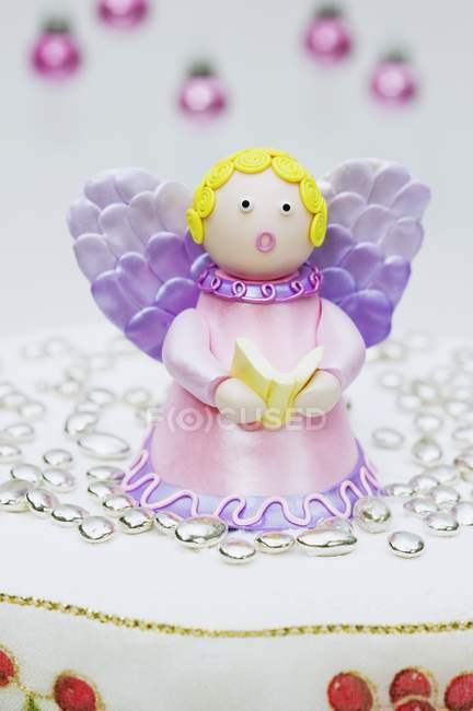Christmas cake with angel decoration — Stock Photo