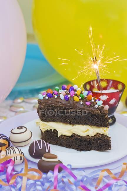Chocolate cake with colorful sprinkles — Stock Photo